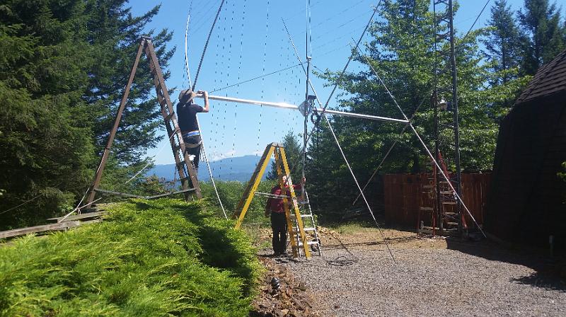 20150728_142223.jpg - Sandy and Marc getting ready to lift the antenna to the top of the tower.