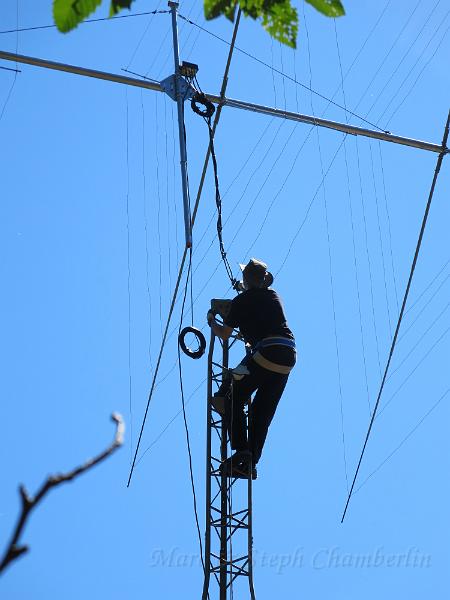 IMG_0661.JPG - Marc getting ready to grab the antenna mast and help guide it into the thrust bearing at the top of the tower.